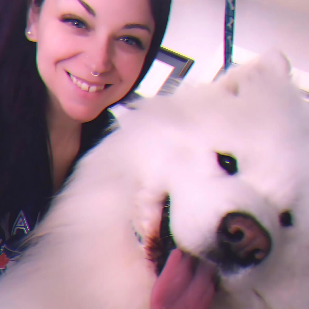 Kirkland Lake Dog Groomer Christina from Critter Cutz smiling with a happy client after a professional grooming session.