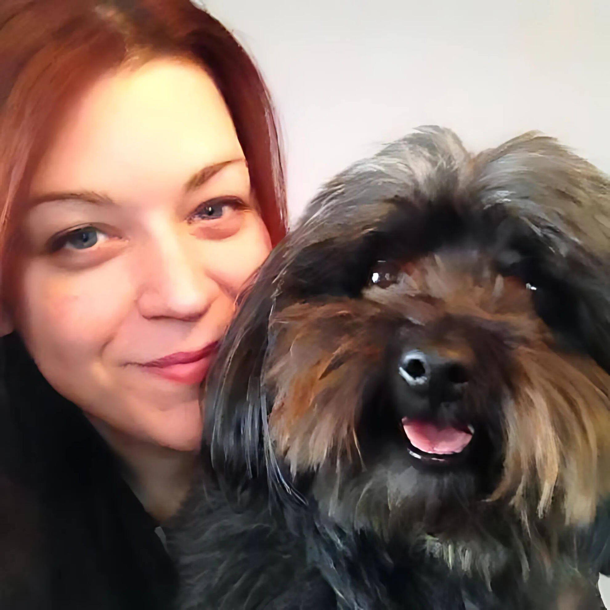 Kirkland Lake Dog Groomer Christina from Critter Cutz smiling with a freshly groomed, happy dog in her home-based salon.